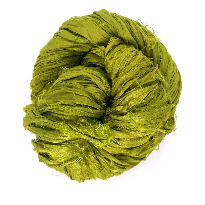 Ball of tangled bright green yarn against a white background.