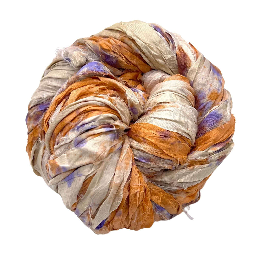A rolled fabric blend in white, orange, and purple colors.