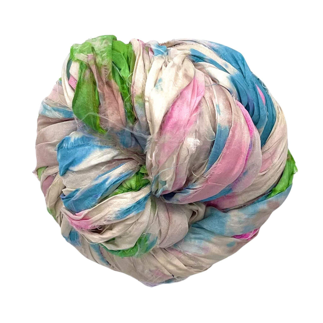 Bundle of pastel-colored fabric with green, blue, pink, and white swirls.